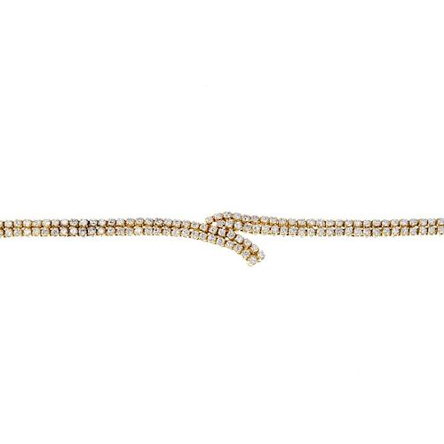(541162-4-A) An 18ct gold diamond bracelet. Designed as two brilliant-cut diamond rows, asymmetrical