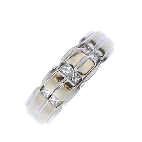 (541441-5-A) A diamond band ring. The grooved band, with three square-shape diamond rows inset, to t