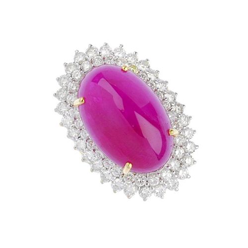(541623-4-A) A ruby and diamond cluster ring. The oval ruby cabochon, within a brilliant-cut diamond