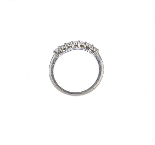 (541826-3-A) An 18ct gold diamond seven-stone ring. The brilliant-cut diamond line, to the tapered s