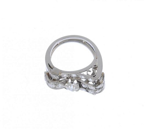 (542447-1-A) A mid-20th century diamond cocktail ring. The old and circular-cut diamond stylised buc