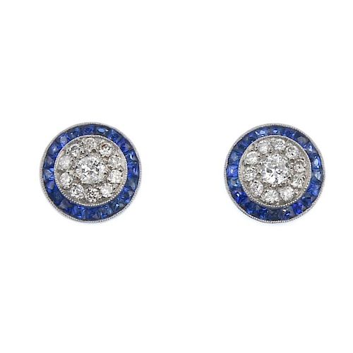 (542447-3-A) A pair of diamond and sapphire earrings. Each designed as a brilliant-cut diamond clust