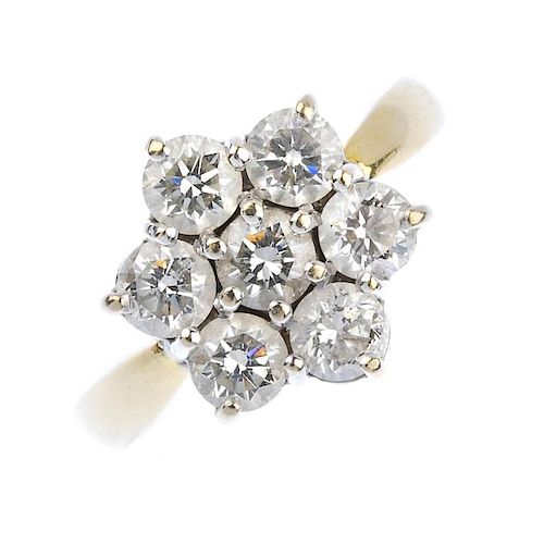 (163989) An 18ct gold diamond cluster ring. Of floral design, the brilliant-cut diamond cluster to t