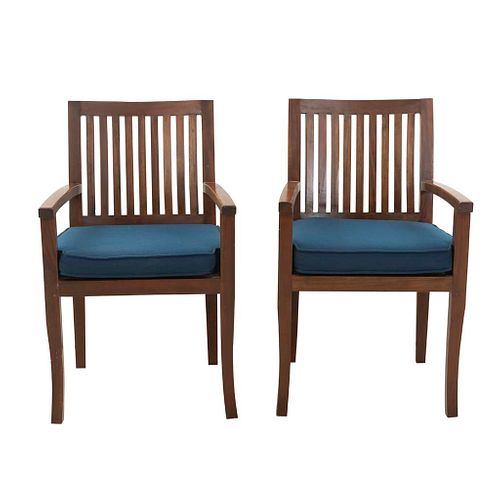 Par de sillones. SXX. Elaborados en madera. Con respaldos calados y asientos con cojines en tapicería color azul.