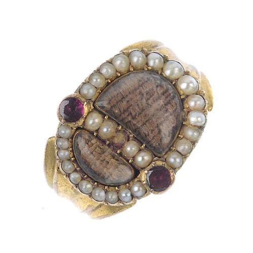 An early Victorian gem-set memorial ring. The two woven hair panels, within a split pearl surround,