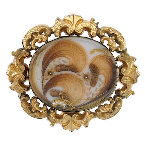A late 19th century memorial brooch. The sculpted hair and split pearl panel, with photograph revers