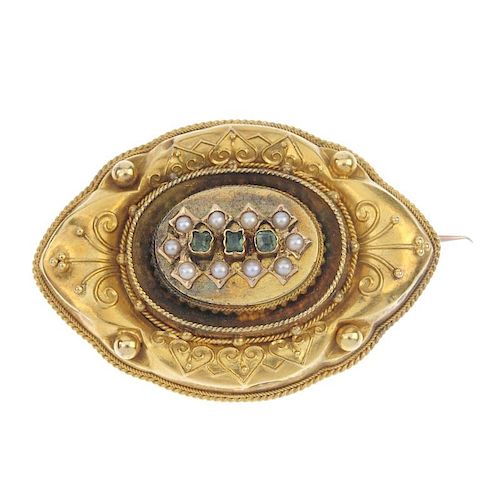 A late 19th century gold gem-set memorial brooch. Of marquise-shape outline, the foil back green-gem