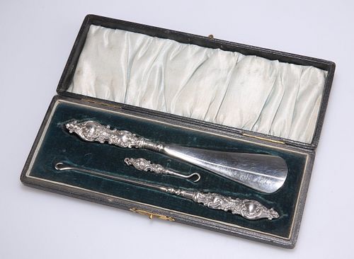 AN EDWARDIAN SILVER-HANDLED BUTTON, GLOVE AND SHOE SET, by 