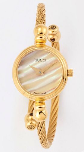 A LADY'S GOLD PLATED GUCCI BANGLE WATCH, circular mother-of