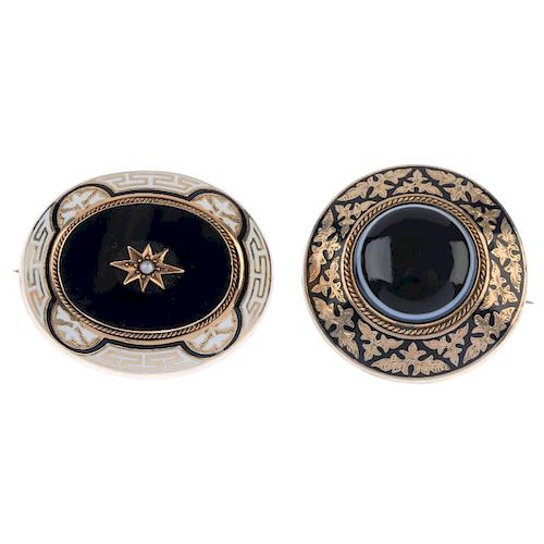 Two late Victorian gold and enamel mourning brooches. The first designed as a split pearl star and o