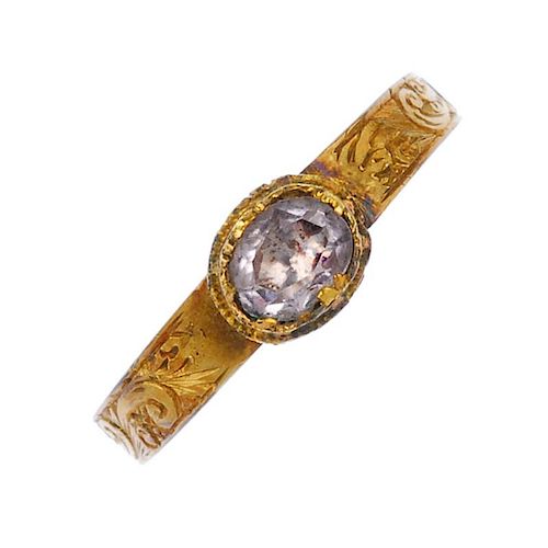 A mid 19th century rock crystal 9ct gold ring. The oval-shape foil-back rock crystal, to the scroll