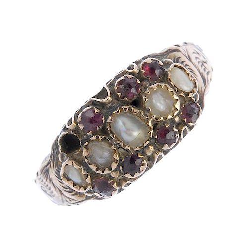 A late Victorian 9ct gold garnet and split pearl ring. The five split pearls within a garnet border,