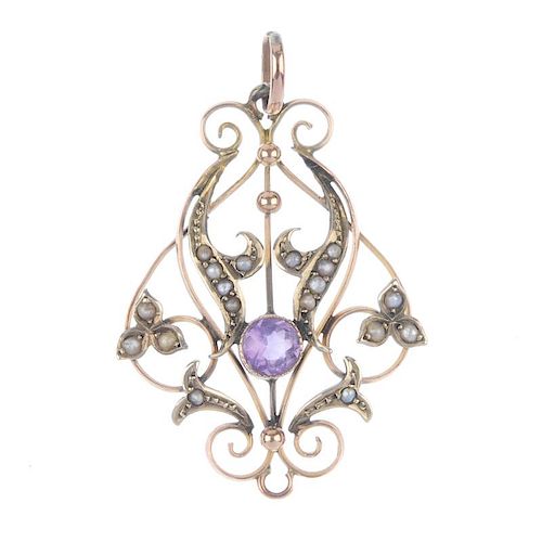 An early 20th century 9ct gold amethyst and split pearl pendant. Designed as openwork scrolls, with
