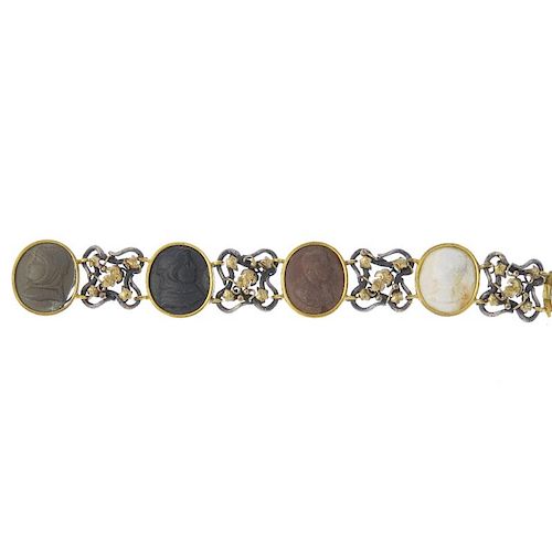 A lava cameo bracelet. Comprising four oval-shape lava cameo panels, of varying tones depicting gent