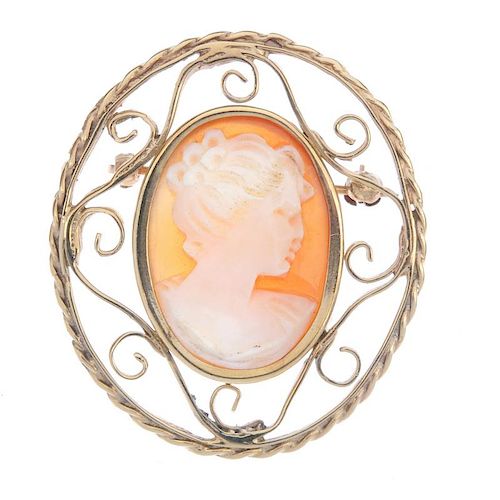 A cameo brooch. The oval cameo a typical profile of a lady, to the open scrollwork surround. Length
