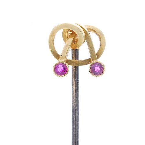 <p>Two stickpins and a peacock brooch. The ruby stickpin of knot design, with circular-shape ruby co
