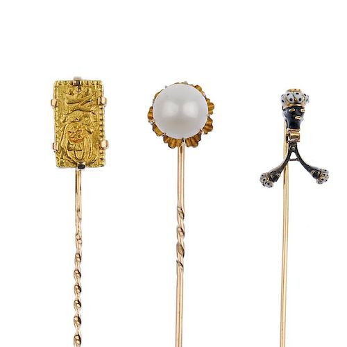 A selection of stickpins. To include two enamel blackamoor stickpins, the first set with a coral cab
