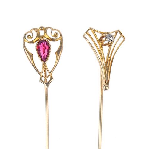 Two stickpins. The first designed as a fluted triangle, with a diamond set to the centre, the second