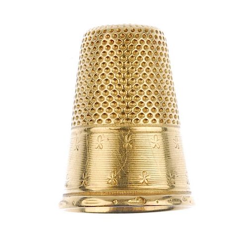 An early 20th century thimble. With vacant cartouche and floral border detail. French assay marks. L