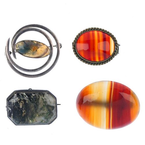 A selection of agate brooches. To include a Malcolm Gray brooch, the curved border to the central ov