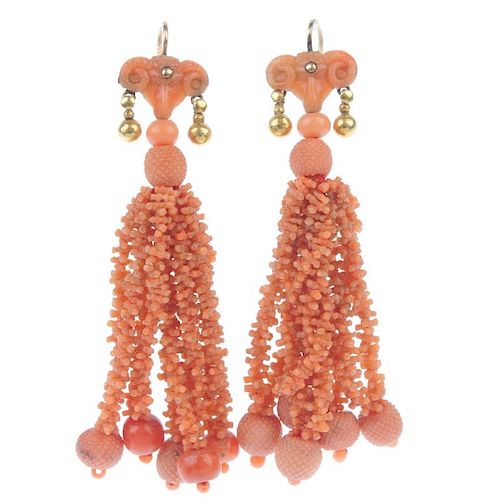 A pair of coral ear pendants. each designed as a carved ram mask, suspending a series of carved cora