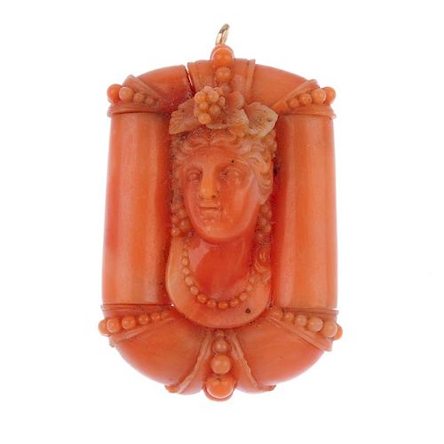 An early 20th century carved coral brooch. The central panel carved to depict a bacchante, within a