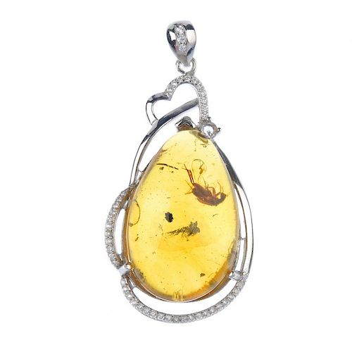 A natural Burmese amber pendant with inclusion. The pear-shape amber cabochon, with clearly visible