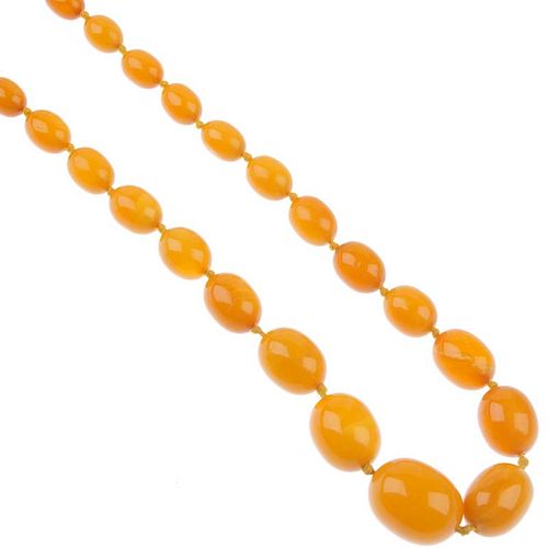 A natural amber necklace. Designed as fifty-one graduated, oval-shape beads measuring 3 to 1cms. Len