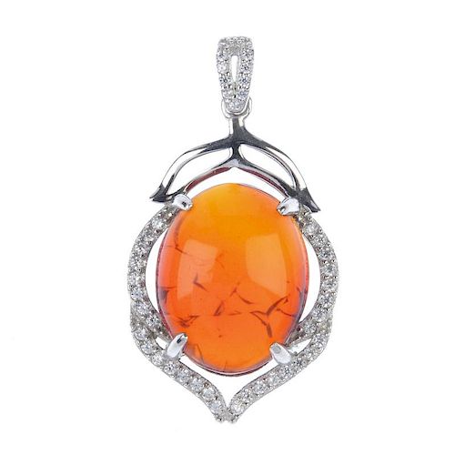 A natural Burmese blood amber pendant. Designed as a blood amber cabochon, measuring 1.7cms, set to