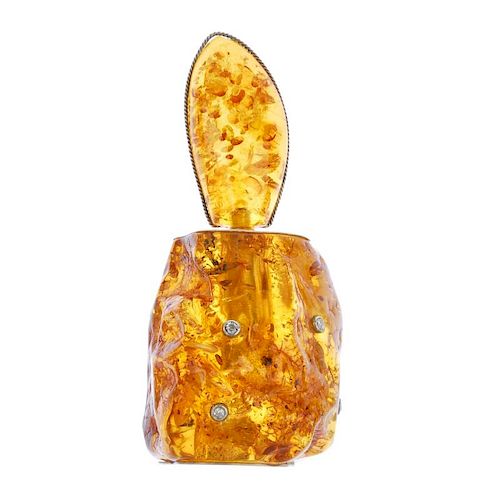 A modified amber scent bottle. The free-form modified amber bottle, with colourless gem highlights,