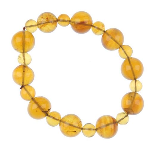A natural Burmese golden brown amber bracelet. Comprising ten spherical beads measuring 1.2cms and a