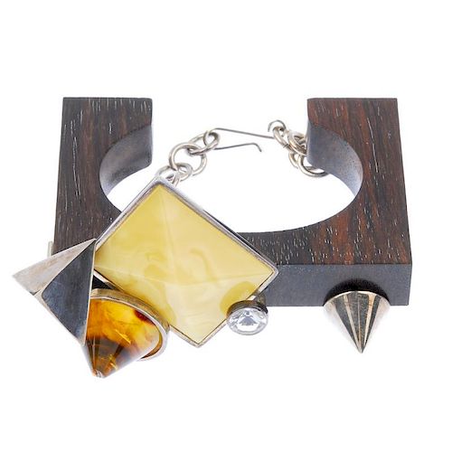 An amber and wood bangle and ring. The ring designed as a square of macassar wood with a pyramid of