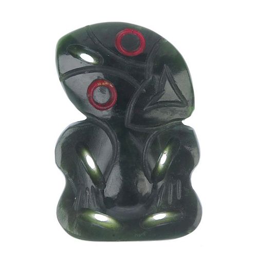 A late 19th century Maori jade hei-tiki or tiki. The dark green Maori jade with red outlines to the