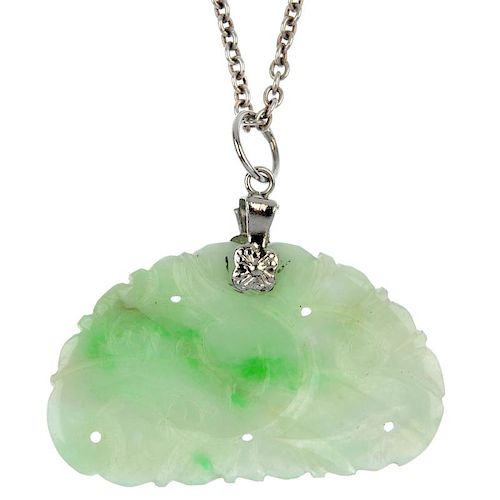 A carved jade pendant. The semi-circular pendant carved with acanthus leaf designs suspended from th