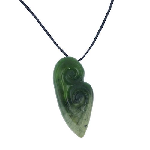 A carved New Zealand jade double Koru pendant by Paddy Cooper. The Koru representing an unfurling fe