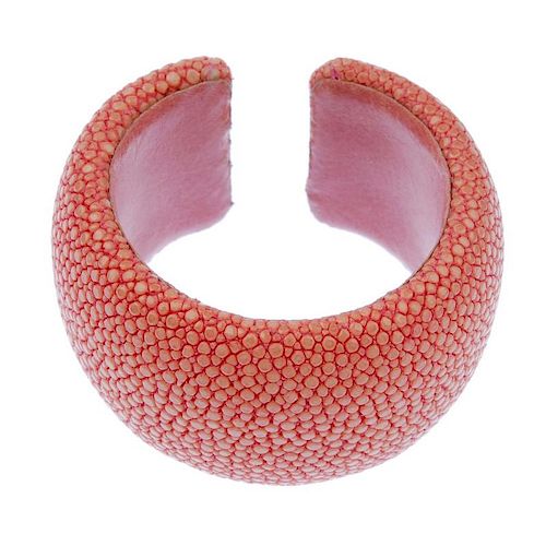A dyed pink stingray cuff. Signed Maximos. Inner diameter 5.2cms. Width 4cms. <br><br>Overall condit