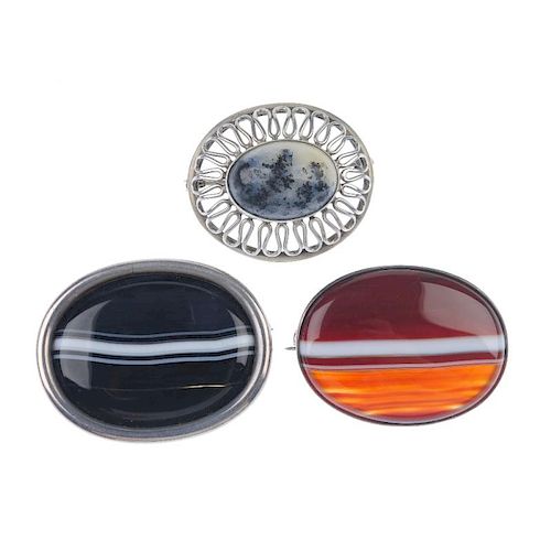 A selection of white metal gem-set jewellery. To include two oval-shape banded agate panel brooches,