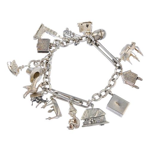 A silver charm bracelet. The belcher and fetter-link bracelet, suspending a series of sixteen charms