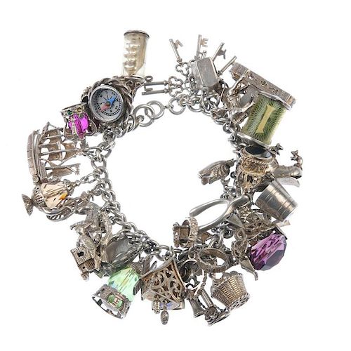 Two charm bracelets. The curb-link chains, suspending a total of seventy charms, to include a miniat