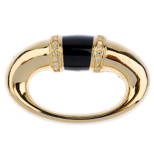 CHRISTIAN DIOR - a brooch. Of oval outline, the central tapered black enamel band with colourless pa