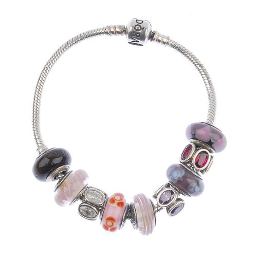 PANDORA - a charm bracelet. With nine charms including five glass charms, one wooden charm and three