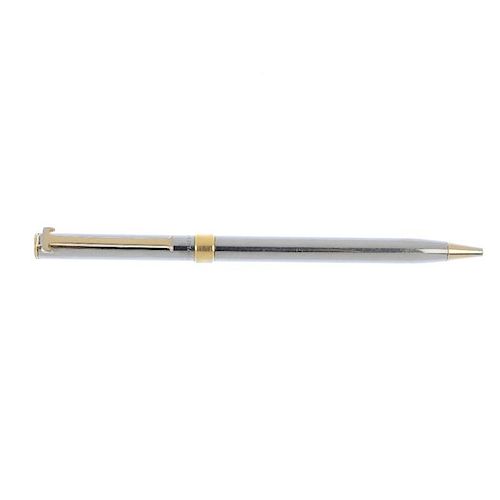 TIFFANY & CO.- a ballpoint pen. The silver-tone pen with gold-tone 'T' clip, ring and point and retr