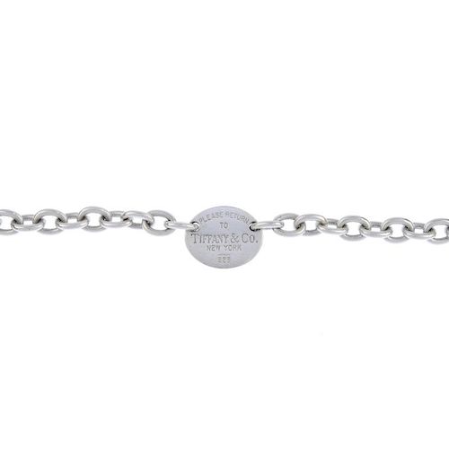 TIFFANY & CO. - a bracelet. Designed as a central oval panel with 'Please return to Tiffany & Co. Ne