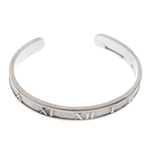 TIFFANY & CO. - an atlas bangle. The plain bangle with Roman numeral motif. Signed and dated Tiffany