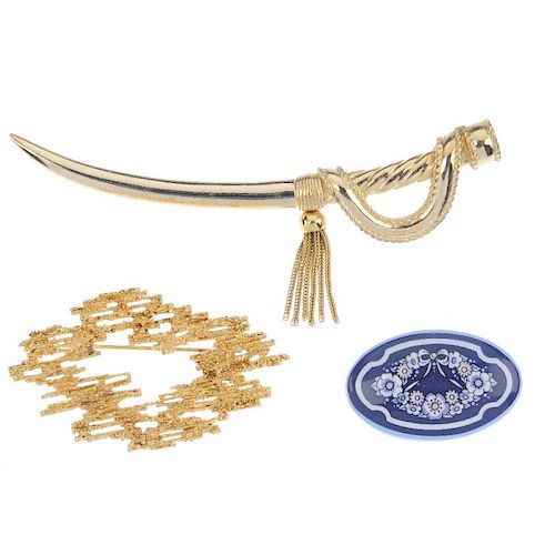 Three designer brooches. The first a Christian Dior brooch in the form of a gold-tone cutlass, suspe