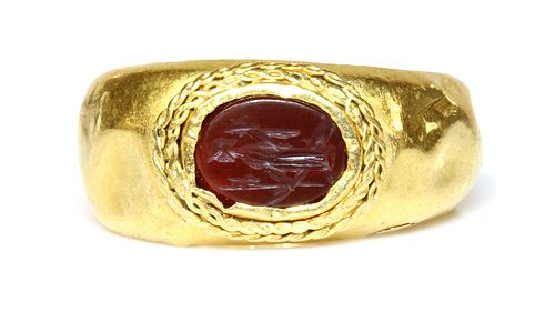 A Roman gentlemen's high carat gold cornelian intaglio ring,