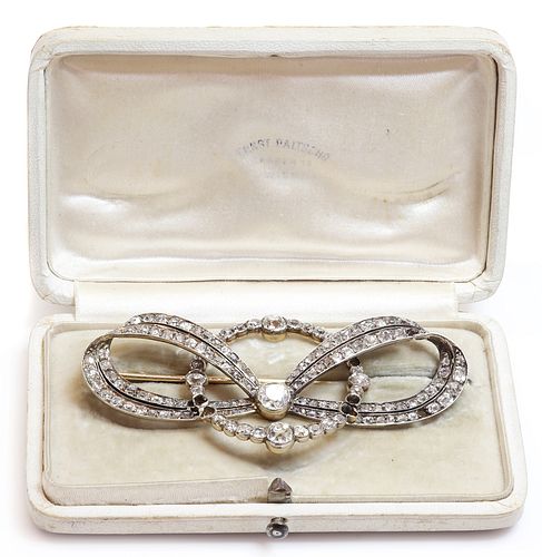 A cased former Austro-Hungarian diamond set bow and hoop brooch, by Ernest Paltsho, Vienna, c.1900,
