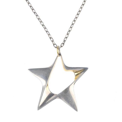 GEORG JENSEN - a silver star pendant. Of bi-colour design, the openwork star, suspended from a belch