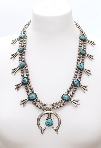 A silver Navajo turquoise squash blossom necklace,
