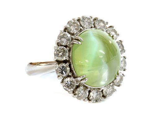 A platinum, chrysoberyl cat's eye and diamond oval cluster ring,